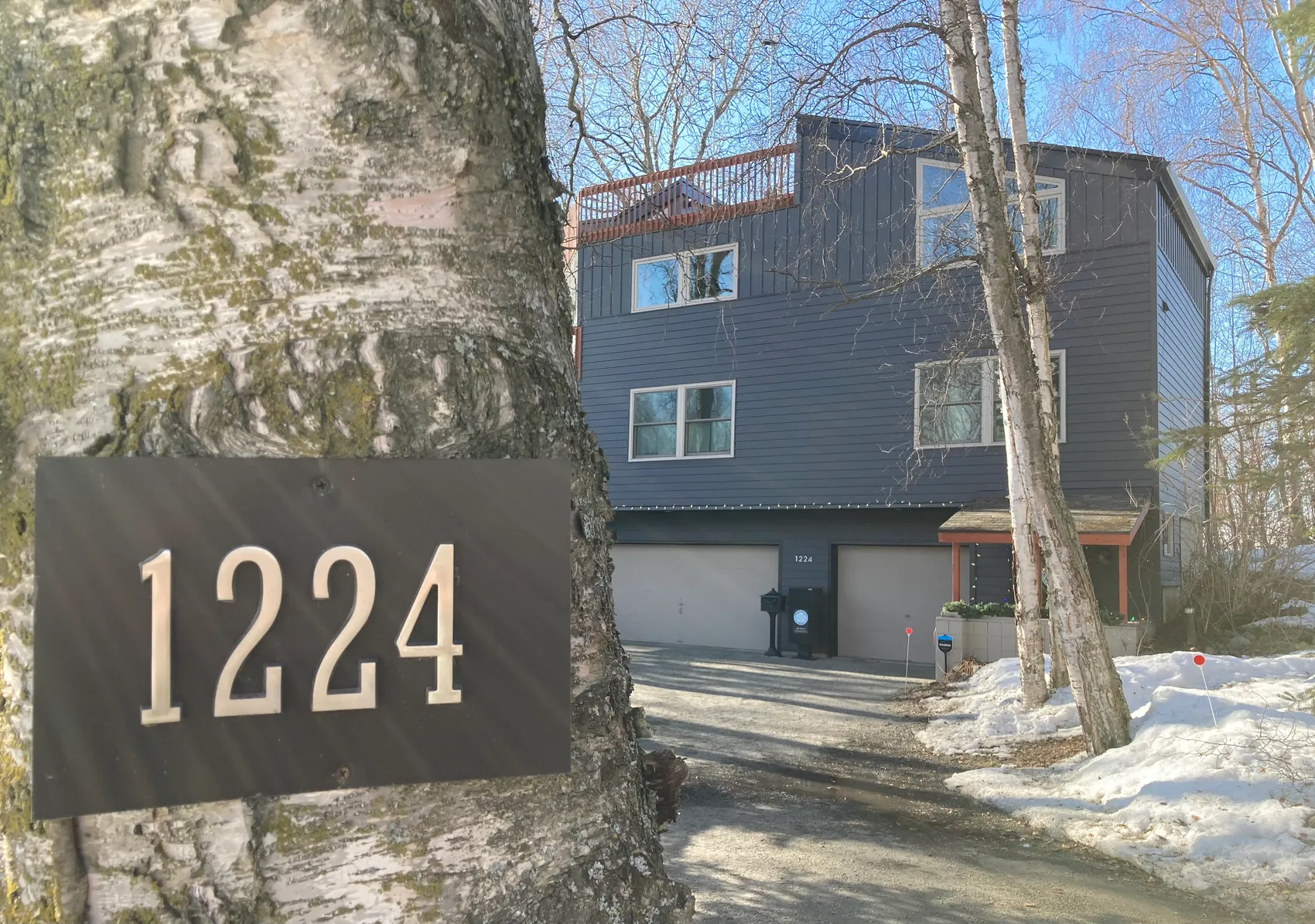 The Forget-Me-Not Media studio building on U Street, with the 1224 address plaque mounted on a birch tree